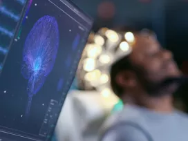 Monitor showing EEG reading of human brain for biomechanical product evaluation and product safety testing